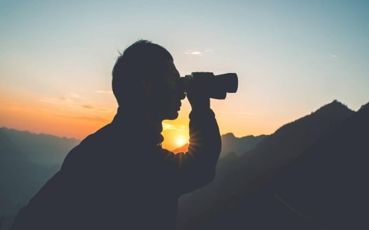 Человек смотрит в бинокль